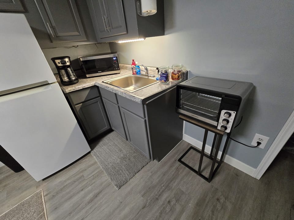 KITCHENETTE WITH TOASTER, MICROWAVE, TOASTER OVEN, COFFEE MAKER, & FRIDGE