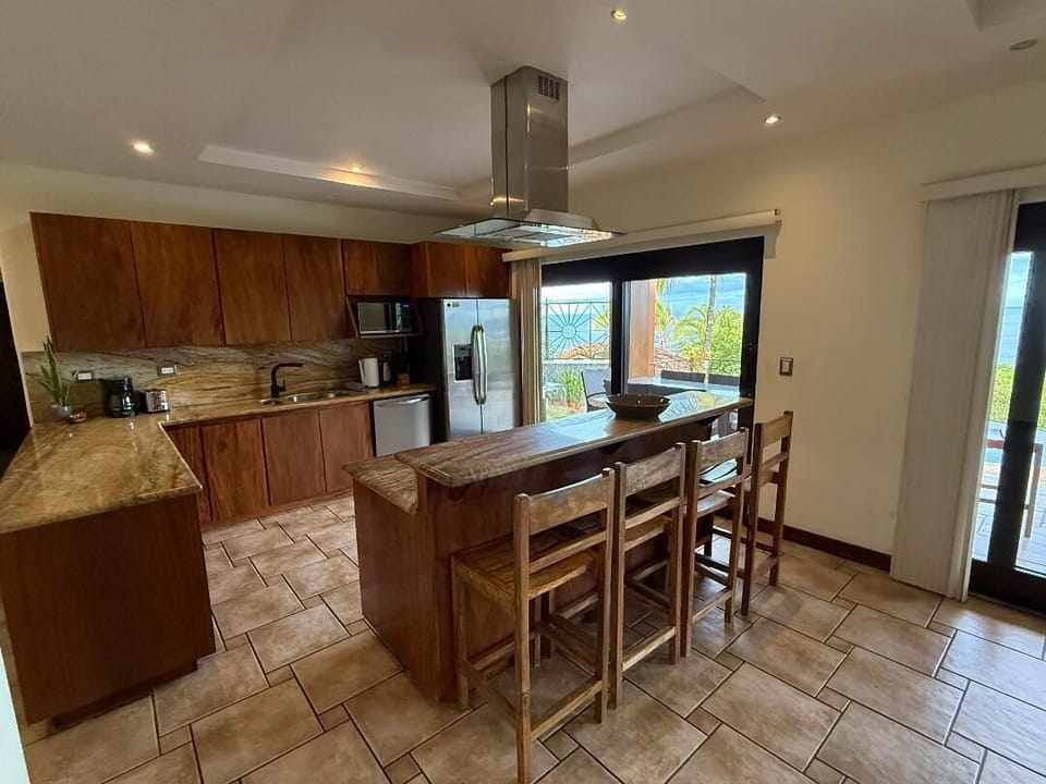 Kitchen with cooks island and Bar