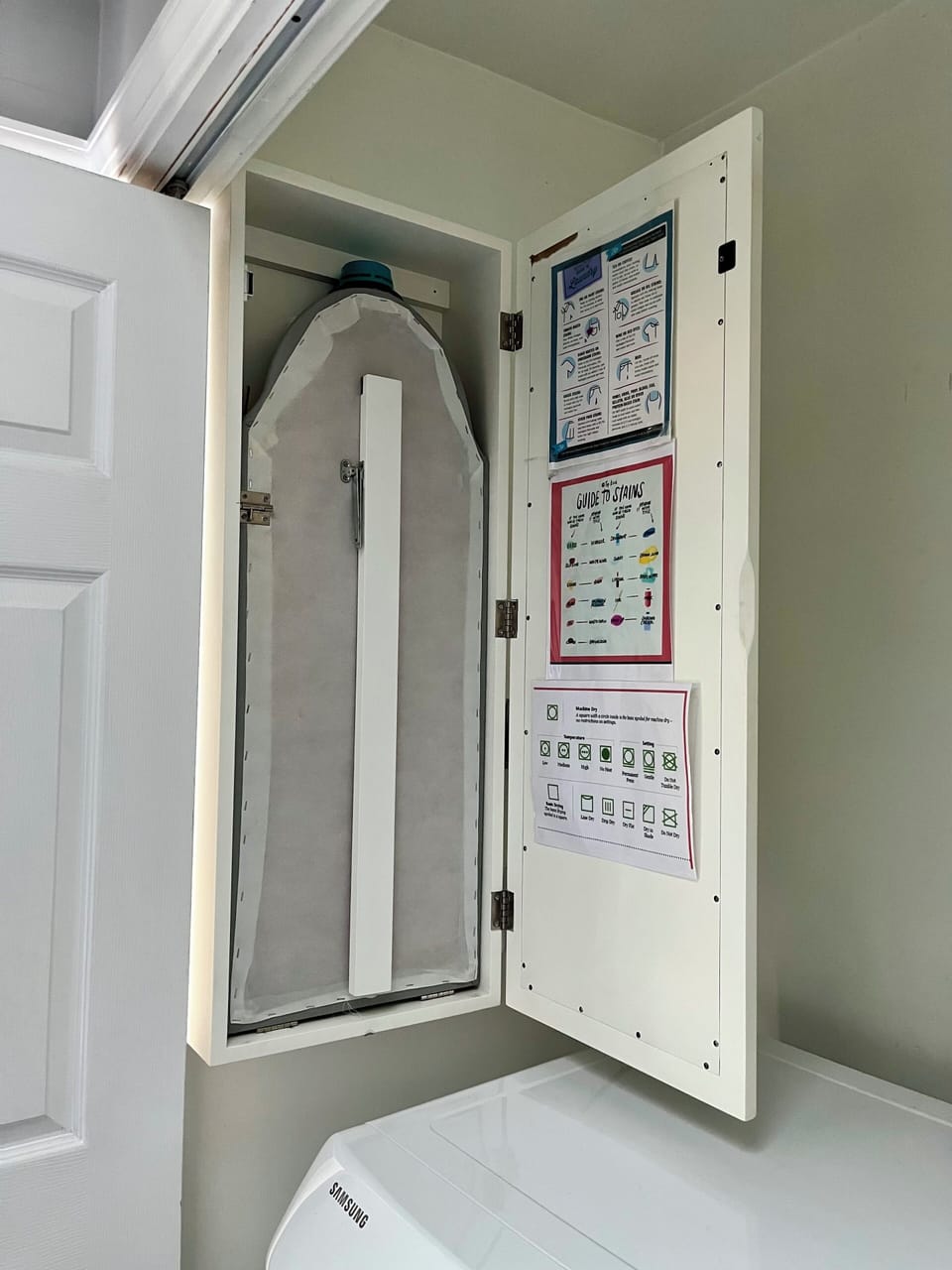 Ironing board in laundry room. 