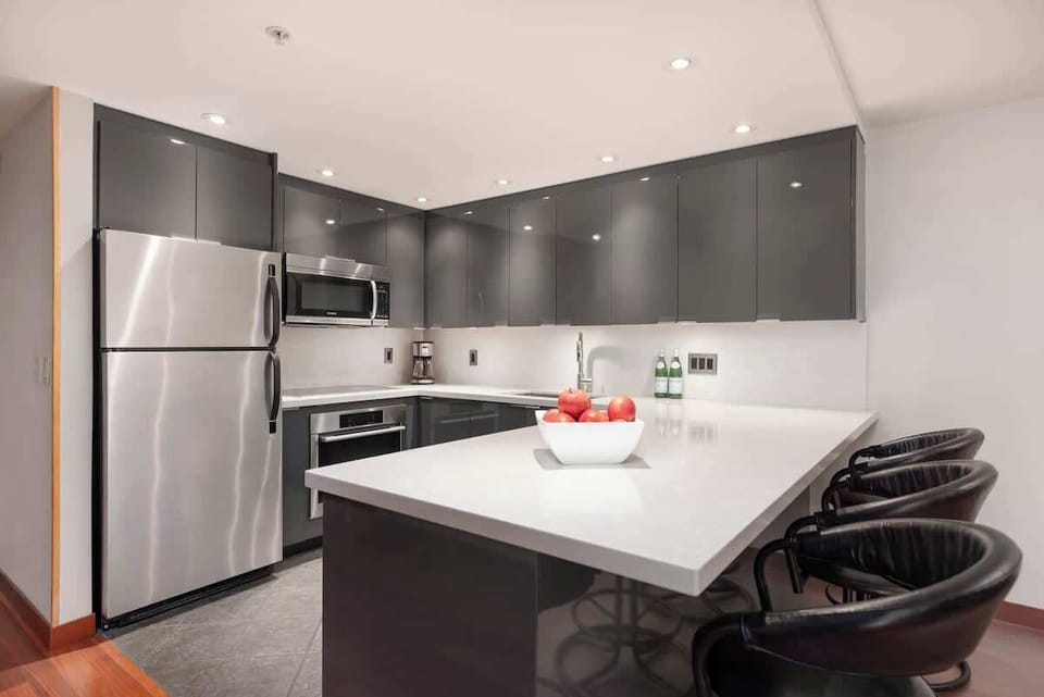 - Modern kitchen with stainless steel appliances and sleek finishes  
- Fully equipped for home-cooked meals during your mountain getaway  
- Spacious island seating perfect for breakfast or evening wine 