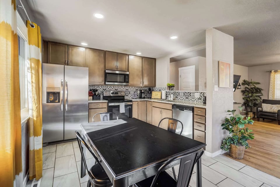 Cook with ease in the fully stocked kitchen, featuring modern appliances, ample counter space, and a stylish dining area perfect for enjoying meals together.






