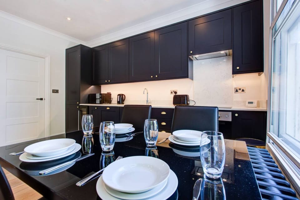Stylish dining area in Fulham London rental, seats four, perfect for meals.