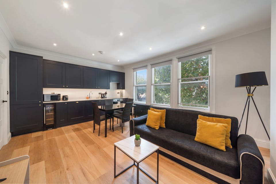 Living room in Fulham London rental with sofa bed, table & cozy space.