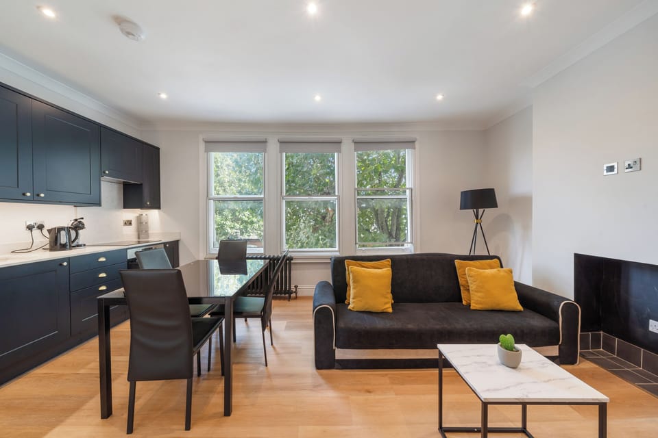 Living room in Fulham London rental with sofa bed, table & cozy space.