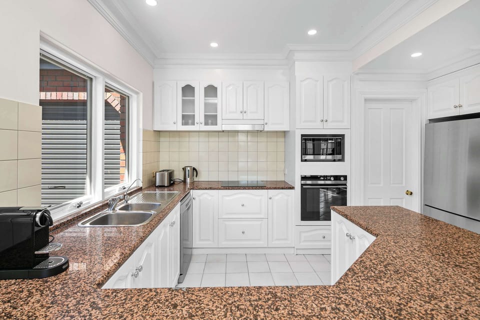 Open Plan Dining and Kitchen Area - with Fully equipped kitchen, 8 seater dining table and mounted SAMSUNG frame TV