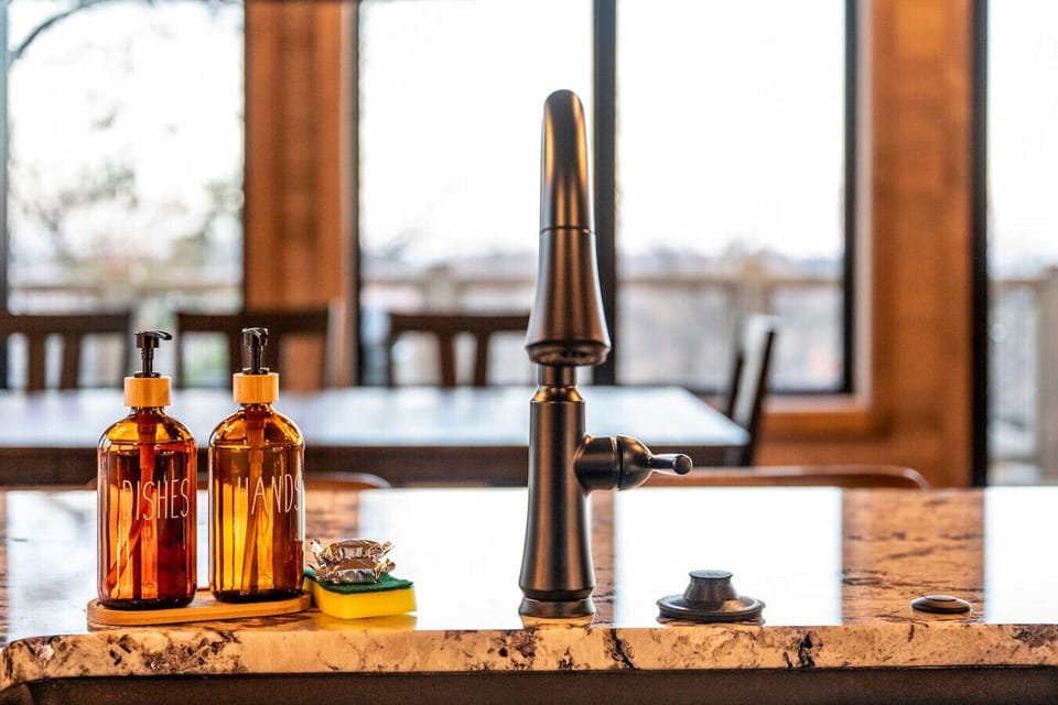 Thoughtful details make your stay at Wellevate Lodge even more comfortable. A stylish kitchen sink with modern fixtures, amber glass soap dispensers, and a clean, inviting space ensure you have everything you need for a relaxing mountain getaway.
