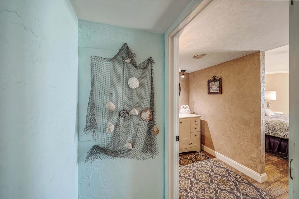 The gulf front master bedroom features a King bed, television, and ensuite bathroom.