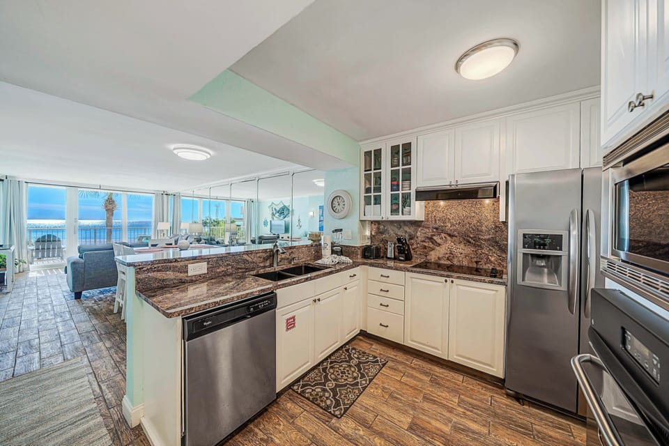 The fully equipped kitchen features granite countertops, stainless-steel appliances, and has everything you need to prepare meals for family & friends.