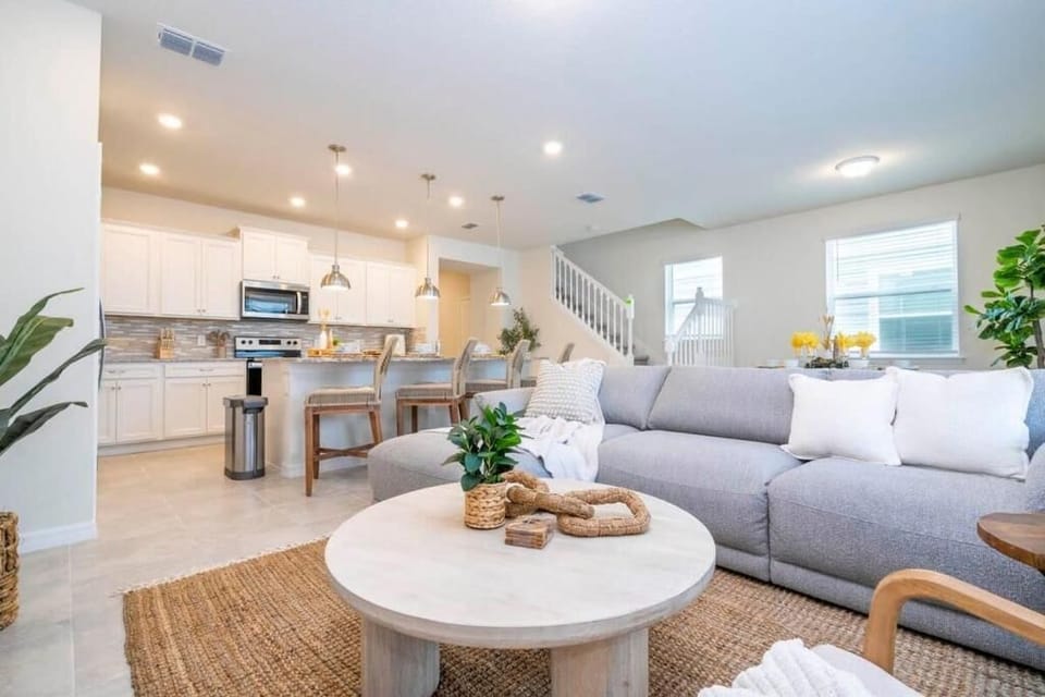 Stylish open layout with modern kitchen, comfy seating, and inviting décor.