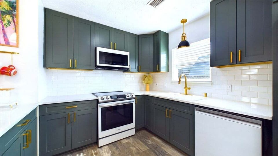 Cook with ease in this updated kitchen, fully equipped with pots, pans, glassware, utensils, sharp knives, a waffle maker, and toaster. Whether preparing a full meal or a quick snack, you'll have everything you need for hassle-free cooking.