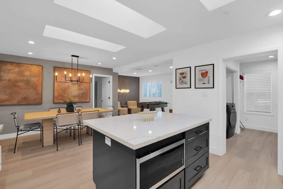 Chef’s kitchen with island, bar stools, and sleek stainless appliances