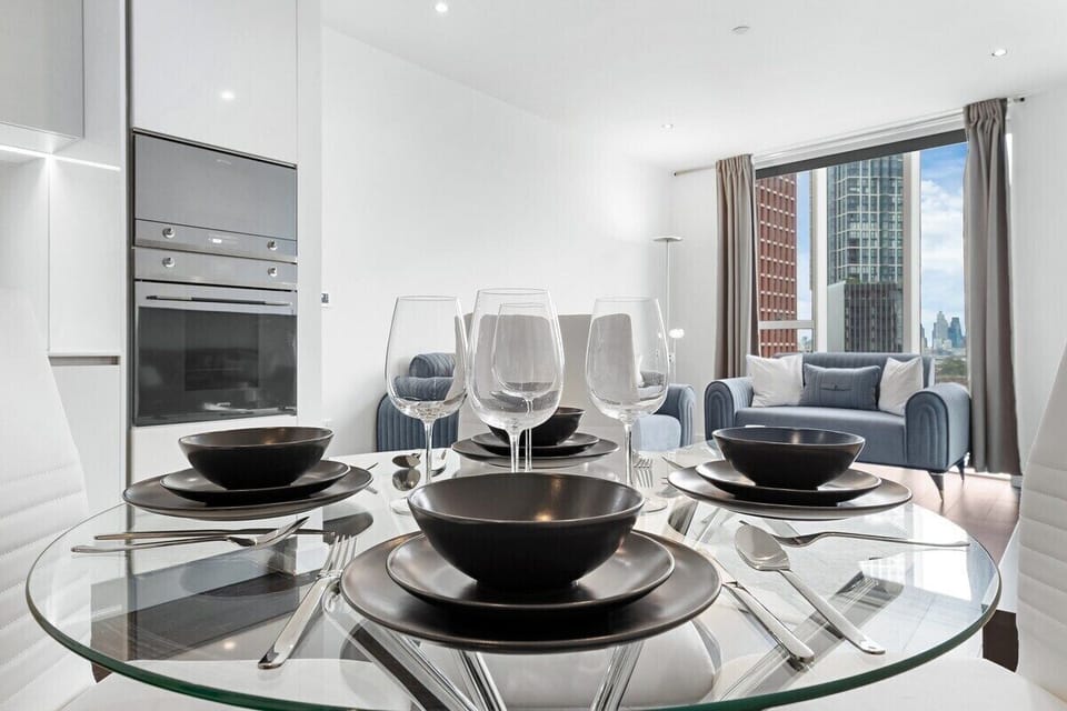 Elegant dining setup with city view living area perfect for relaxing and entertaining