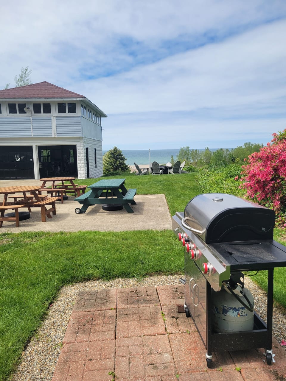 Backyard grilling and plenty of room for  outdoor dining, with umbrellas.