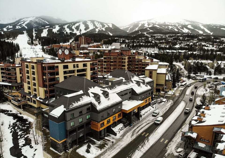 Picturesque alpine village surrounded by breathtaking snow-capped mountains, offering the perfect winter escape.