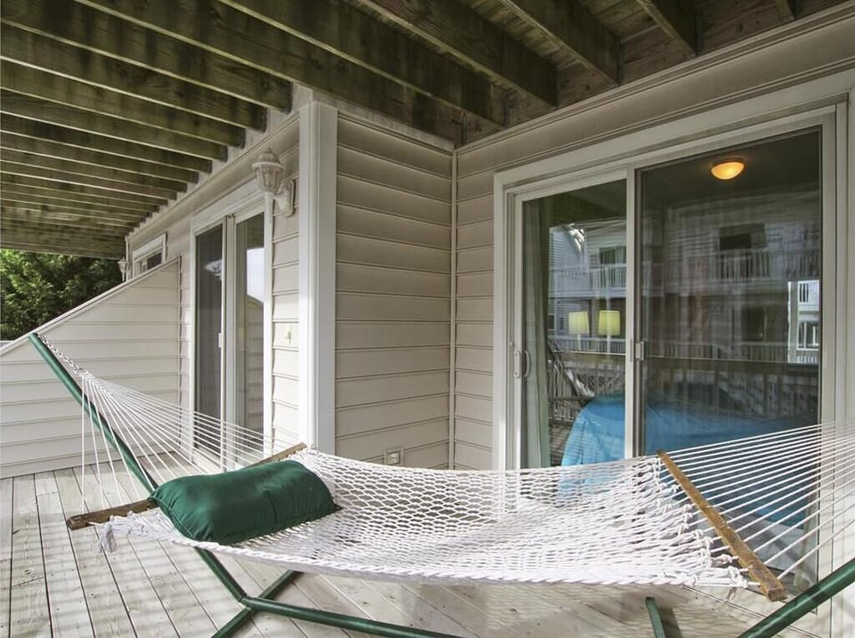 Relax in the shaded hammock on the covered patio, the perfect spot for an afternoon nap.