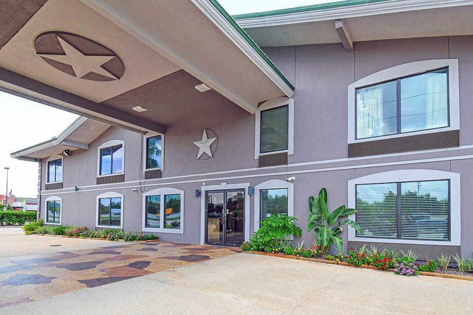 Step into a well-kept entrance framed by fresh landscaping.
