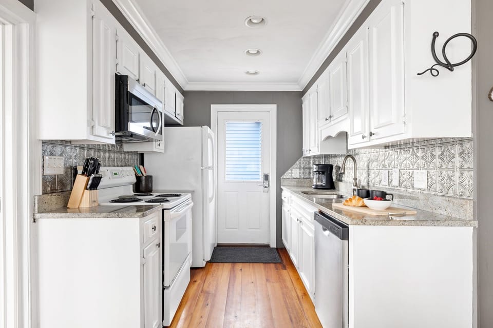 Cook and entertain in style in this open-concept kitchen, featuring  granite countertops and plenty of space to create memorable meals.