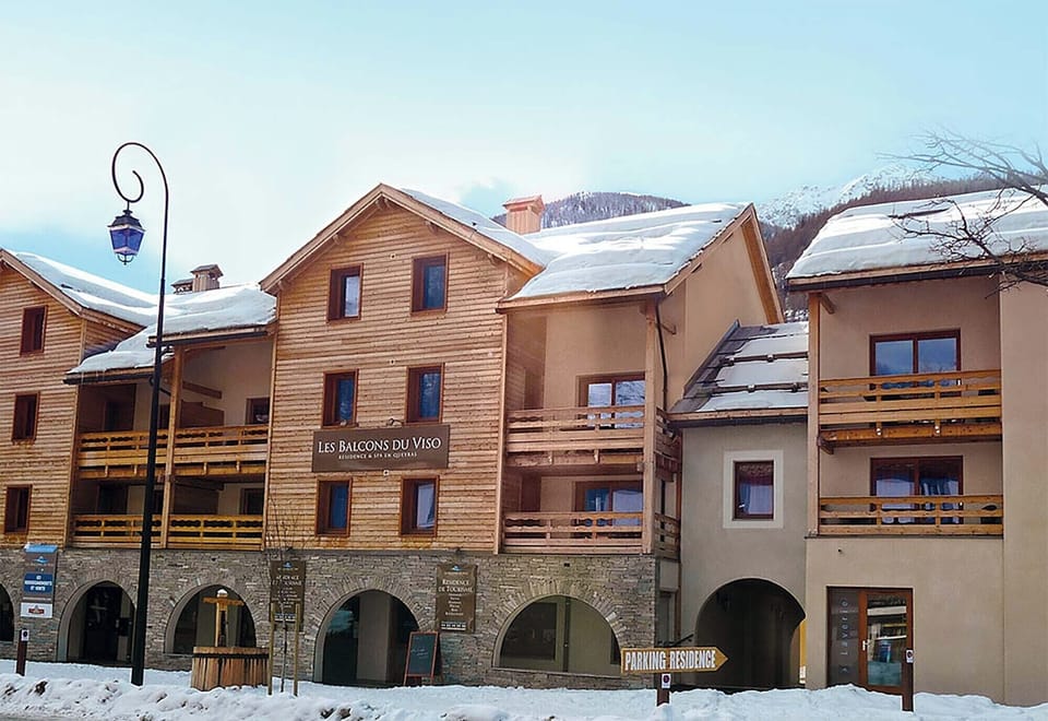 The charming architecture of Les Balcons du Viso, blending harmoniously with the picturesque alpine surroundings.