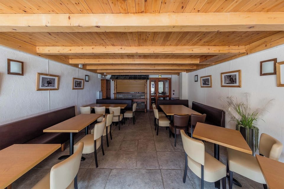 The residence’s cozy dining area, featuring a warm wooden ambiance, perfect for sharing meals in a friendly atmosphere.