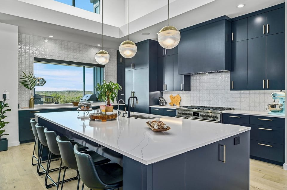 The gourmet kitchen offers plenty of counter space, a variety of appliances, and seating for 5 at the kitchen island.