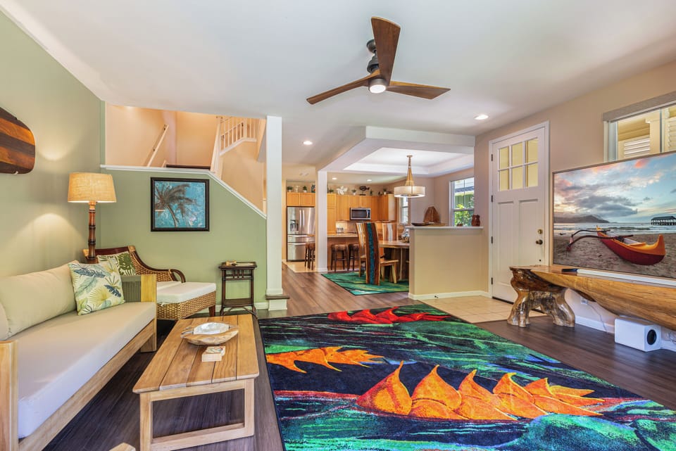 The open floor plan seamlessly connects the living room to the dining and kitchen areas.