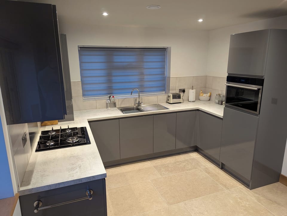 Integral combination microwave oven and tea / coffee making facilities.