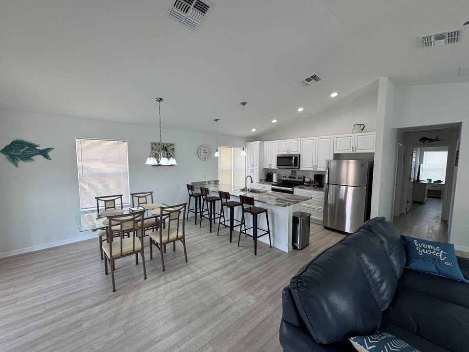Living area, dining table and kitchen