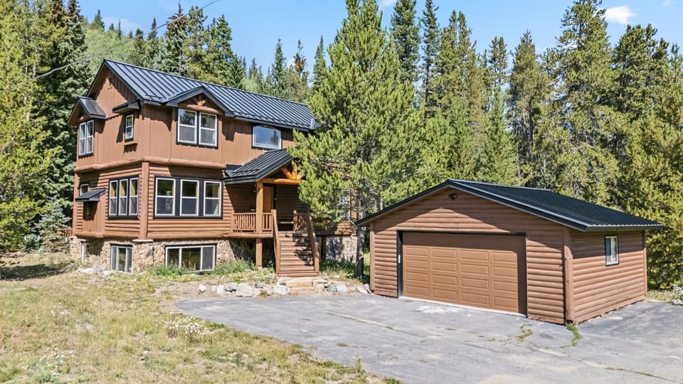 front entrance with 1 car detached garage and plenty of paved parking