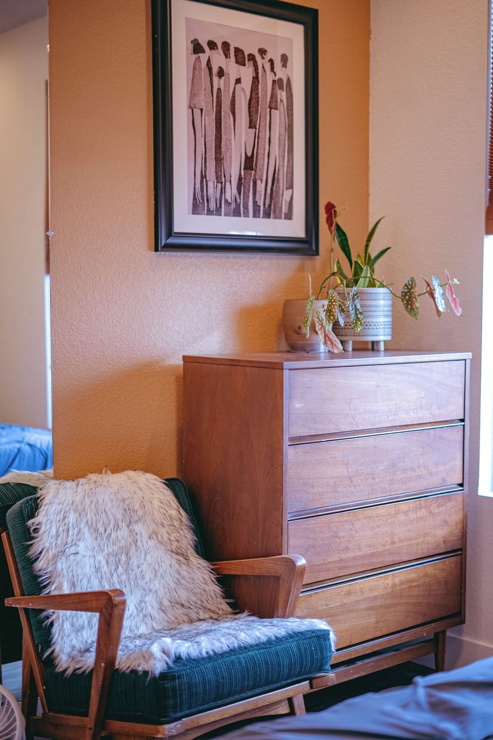 2nd bedroom chair and dresser next to big window.