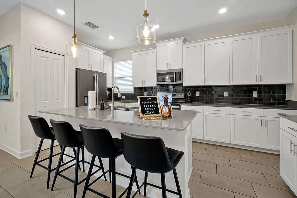 Prepare delicious meals in our sleek, fully equipped kitchen featuring modern appliances, ample counter space, and a breakfast bar