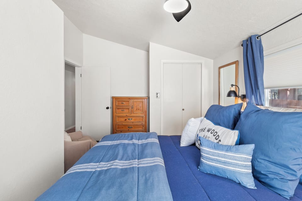 Guest bedroom has a queen-sized bed w/ a closet and dresser for your belongings.