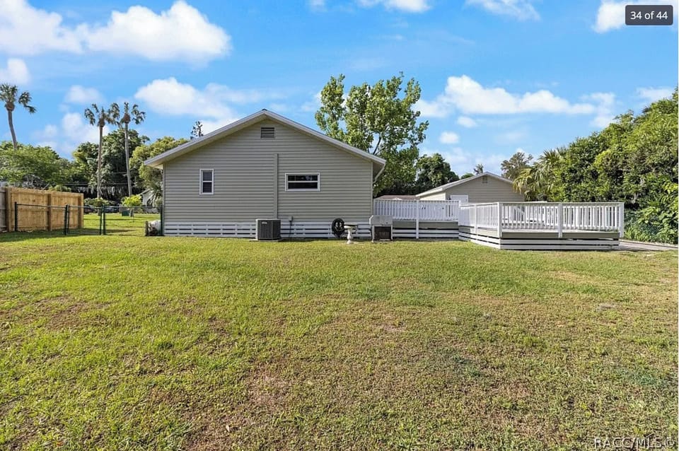 Back of house, porch to the right, full fence of back yard