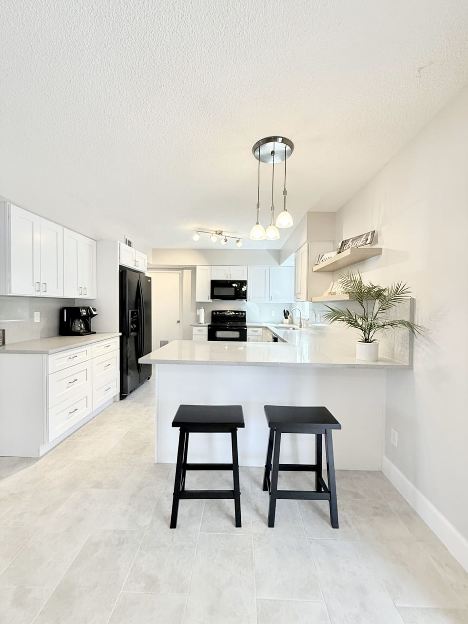 Kitchen features a refrigerator, oven/stove,microwave,dishwasher, & coffee maker