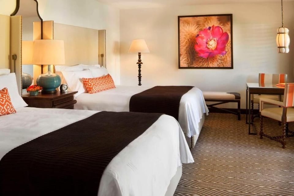 Sink into twin beds beneath artful décor and warm lamps.