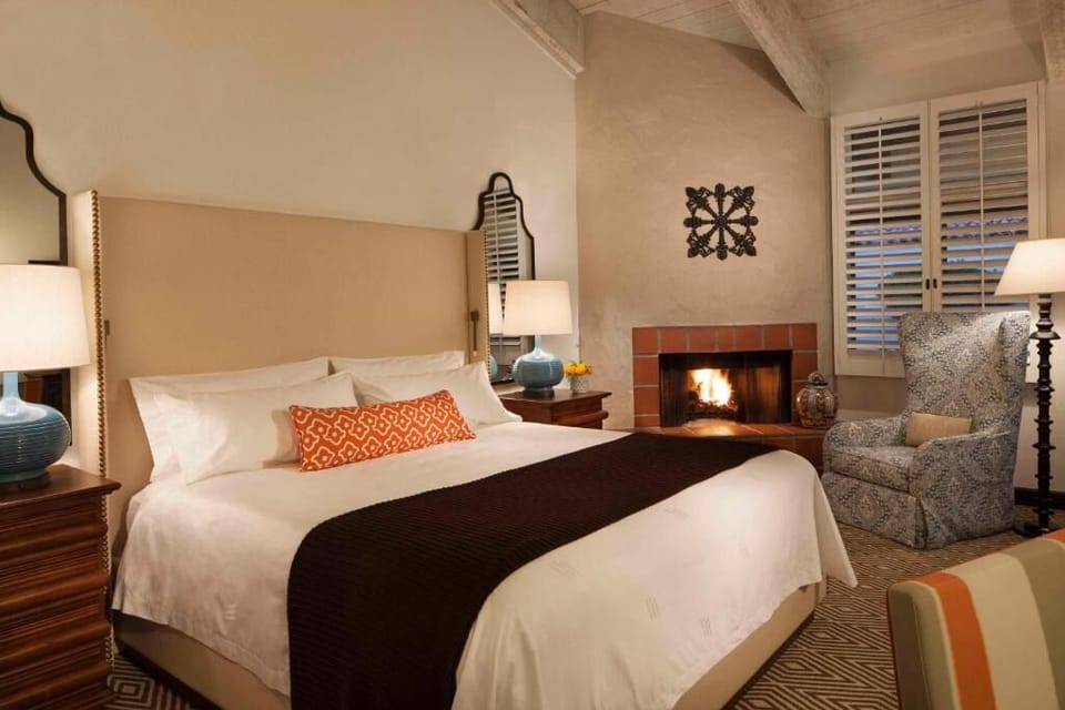 Unwind by the glowing fireplace in crisp, cloud-soft bedding.