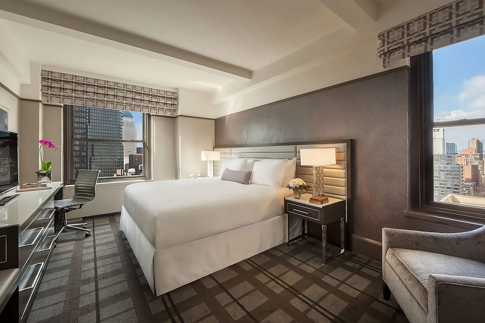 Wake up to sunlit comfort and sweeping city skyline views.