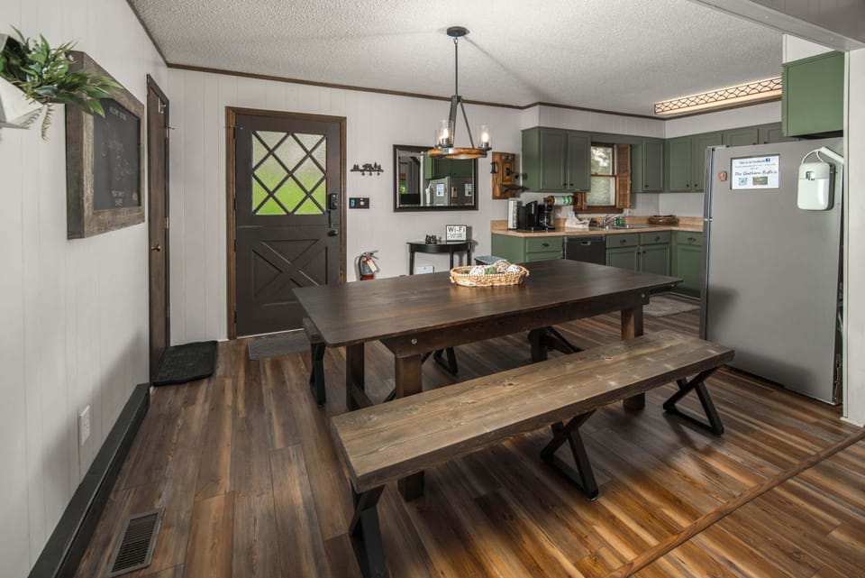 Spacious dining area with bench seating conveniently connected to the fully equipped kitchen and living room