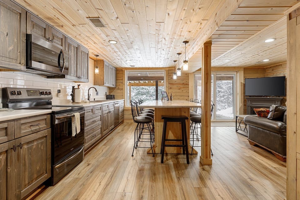 Updated kitchen, fully equipped with a drip coffee maker, toaster, and a spacious island, seamlessly connected to the adjoining living area.