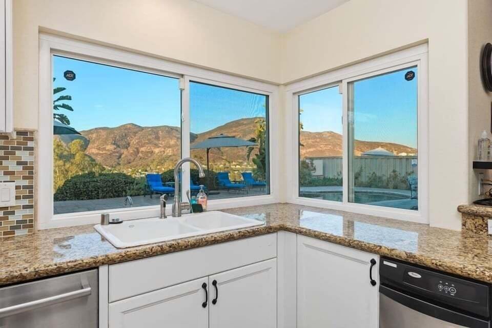 Fully-stocked kitchen with bar stools