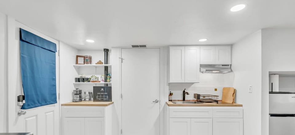 Wake up and start your day with coffee in this bright, simple kitchenette space made for easy mornings.