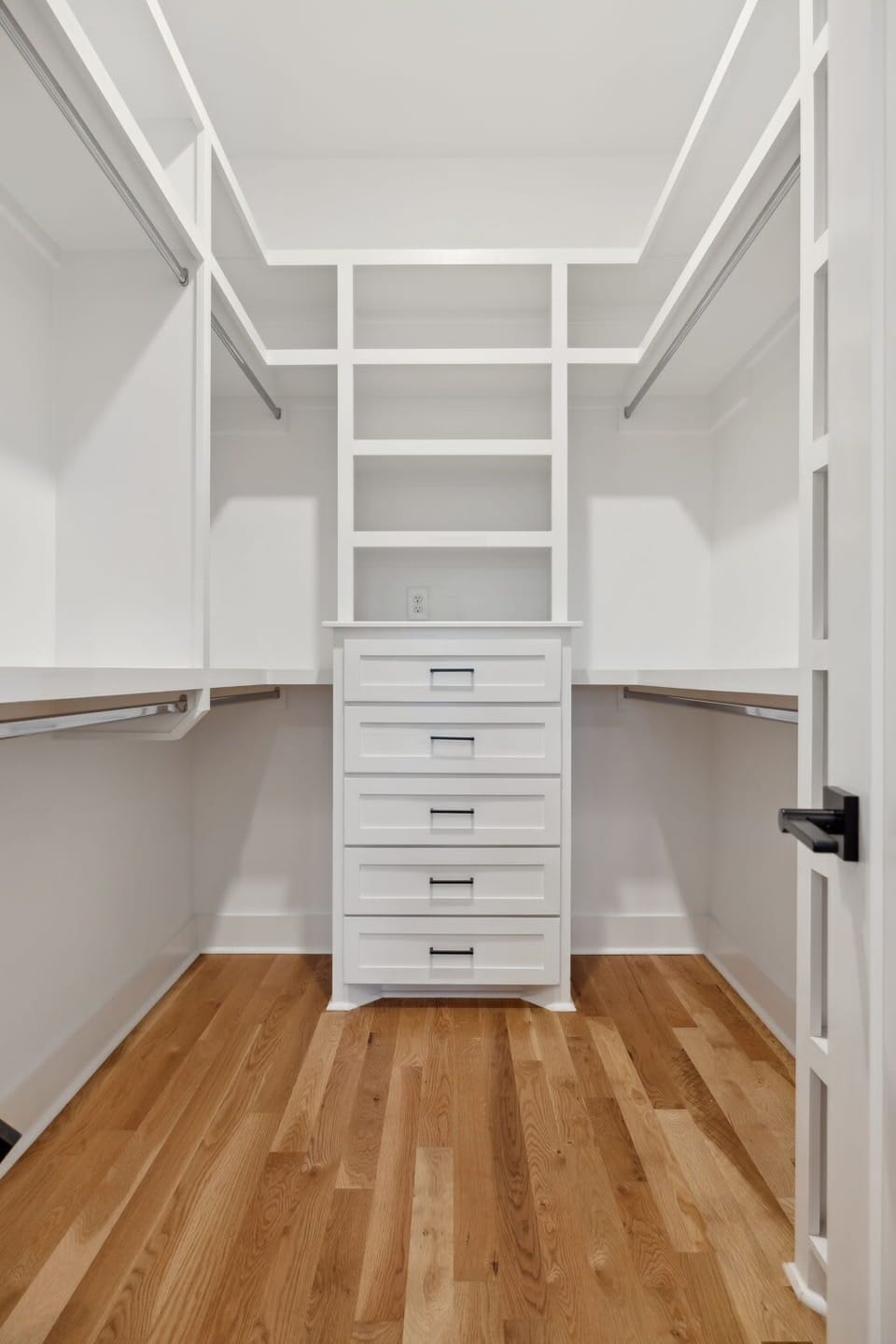 A spacious walk-in closet with built-in shelving and ample storage space for optimal organization.