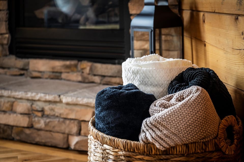 Stay warm and comfortable with soft throws by the fireplace.
