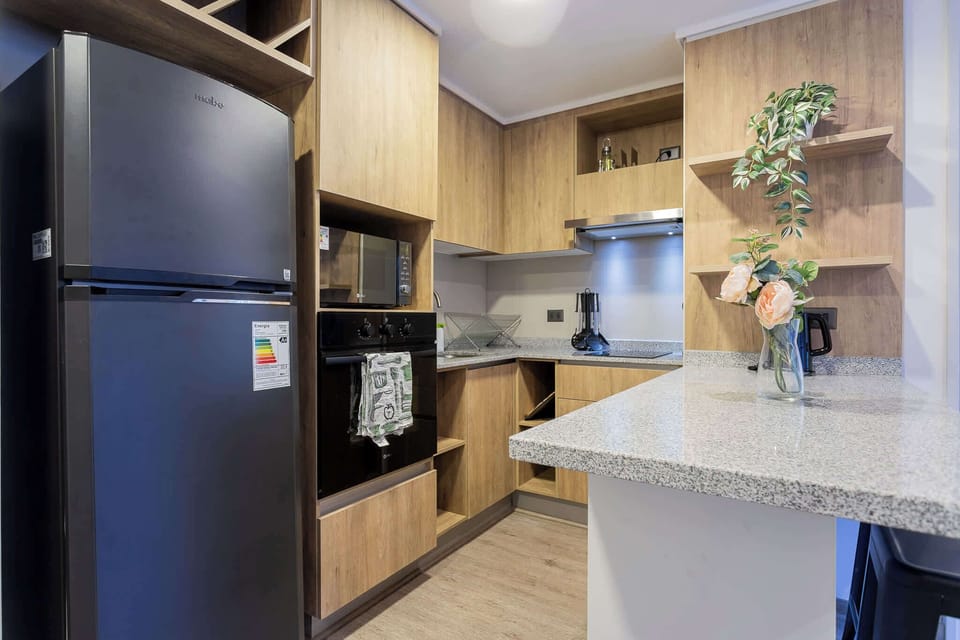 Modern kitchen with sleek appliances and stylish decor, perfect for culinary adventures.