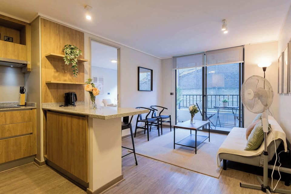 Cozy open-plan living area with a balcony, perfect for relaxing after a day of exploring.