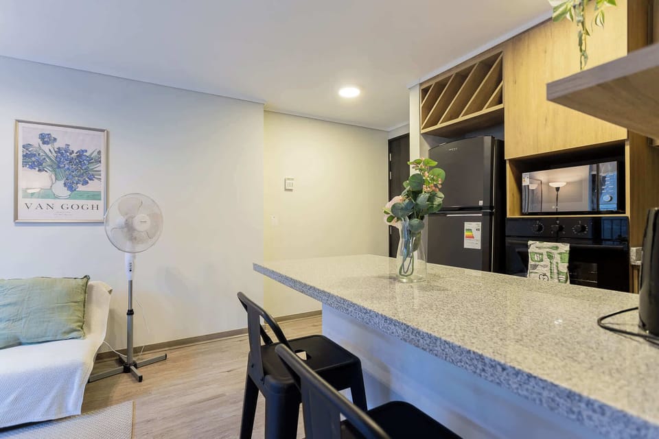 Modern kitchen with sleek granite countertops and stylish decor, perfect for culinary adventures.