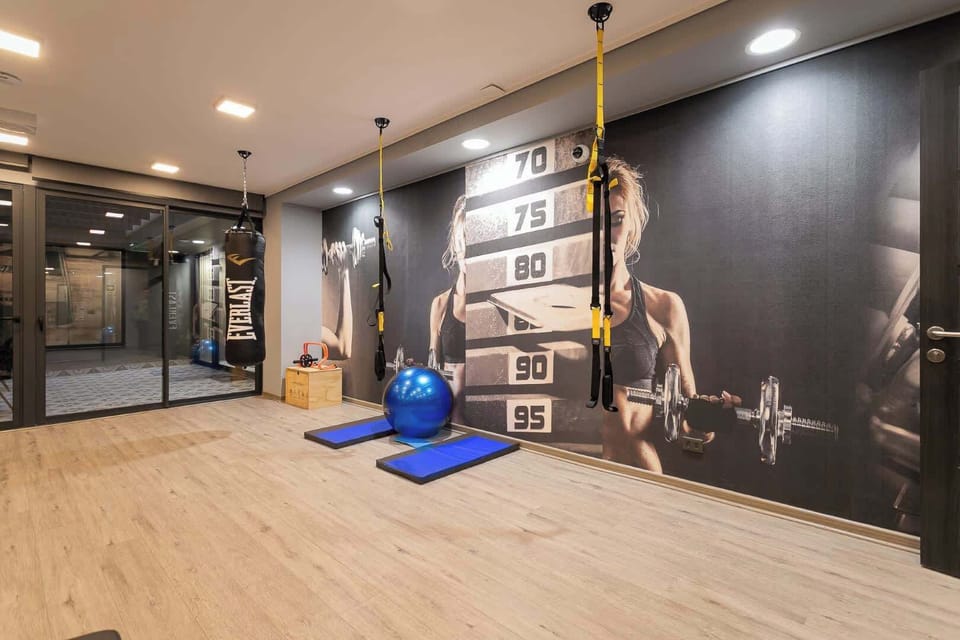Elevate your stay with our fully-equipped gym, featuring a boxing bag, TRX, and stunning motivational decor!