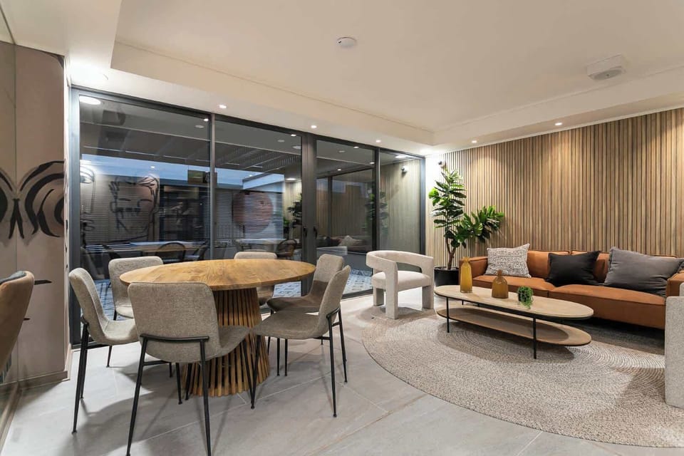 Experience modern elegance in this spacious living area, featuring stylish furniture and abundant natural light for a relaxing stay.