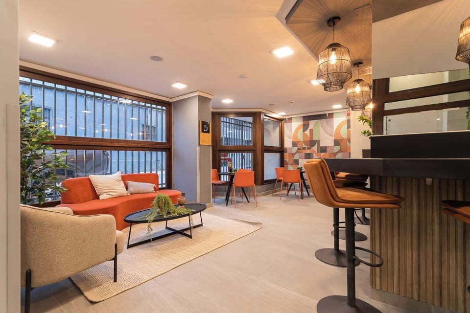Experience modern comfort in this spacious living area, featuring vibrant decor and ample natural light for a refreshing retreat.