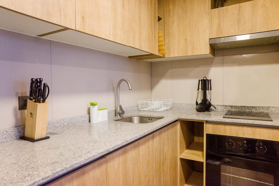 Modern kitchen with sleek granite countertops and all essential amenities for a comfortable stay.