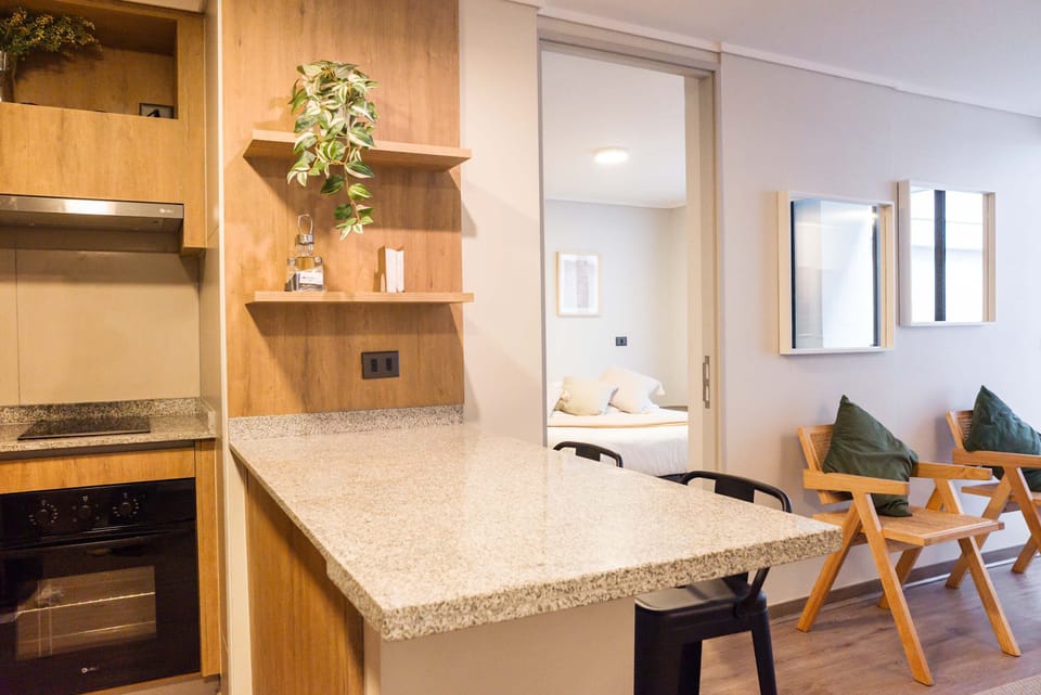 Cozy kitchen with modern amenities and a seamless flow into the bedroom, perfect for a comfortable stay.